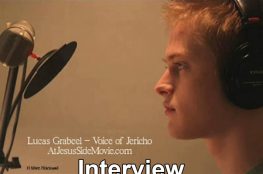 Screenshot of video showing Lucas Grabeel in front of professional microphone.