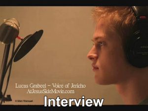 Screenshot of video showing Lucas Grabeel in front of professional microphone.