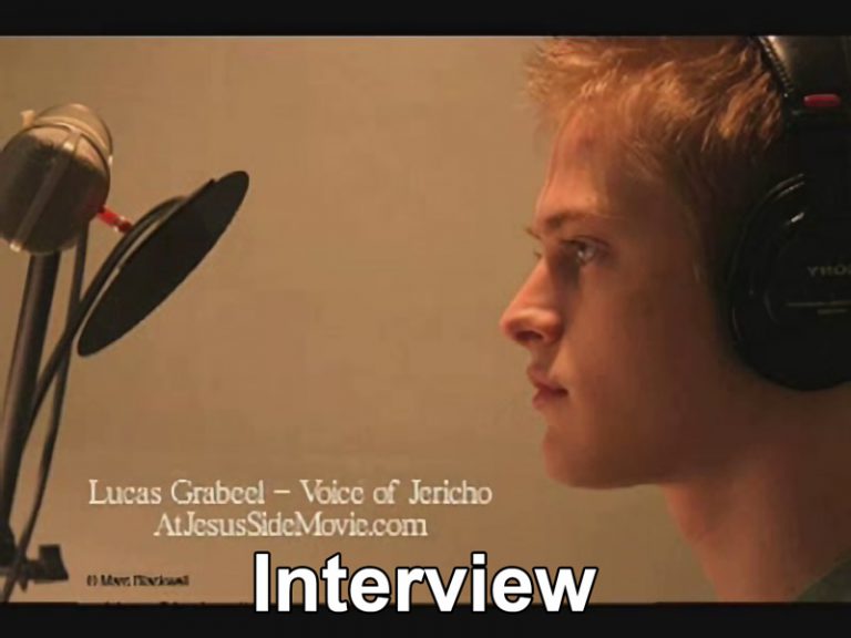 Screenshot of video showing Lucas Grabeel in front of professional microphone.