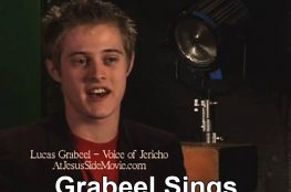 Screenshot of video showing Lucas Grabeel singing.