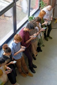 Group of people staring at their smartphones.